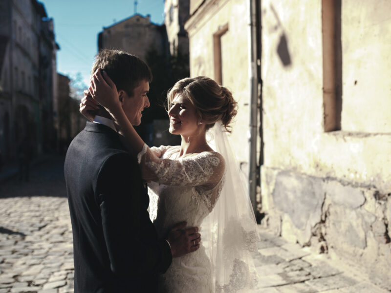 bride and groom posing on the streets of the old town